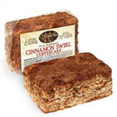 A package of low-carb cinnamon swirl coffeecake is displayed, showcasing a rectangular slice with a brown, cinnamon-sugar topping and a label highlighting its natural ingredients and fiber content.